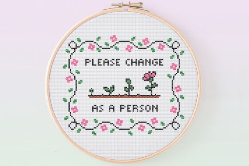 The phrase 'Please change as a person' is surrounding a design of a flower going through the stages of growth. It is surrounded by a wavy border of petals and leaves.